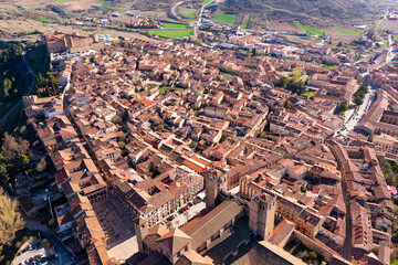 Obraz premium Drone photo of Spanish city Siguenza, Castile-La Mancha. Tiled rooftops of residential buildings and Cathedral visible from above.