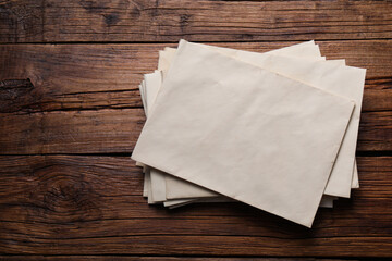 Old letter envelopes on wooden table, top view