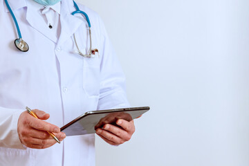 Healthcare doctor takes notes in digital tablet recording patient information