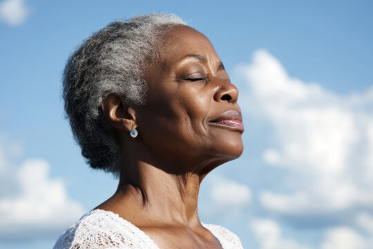 African senior woman taking a breath on a sunny day, mental health