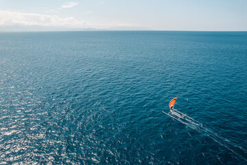 High angle drone view of a sailing ship sailing on the sea