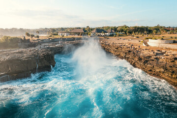 High angle aerial panorama of huge waves at Devil's Tears in Bali, Indonesia