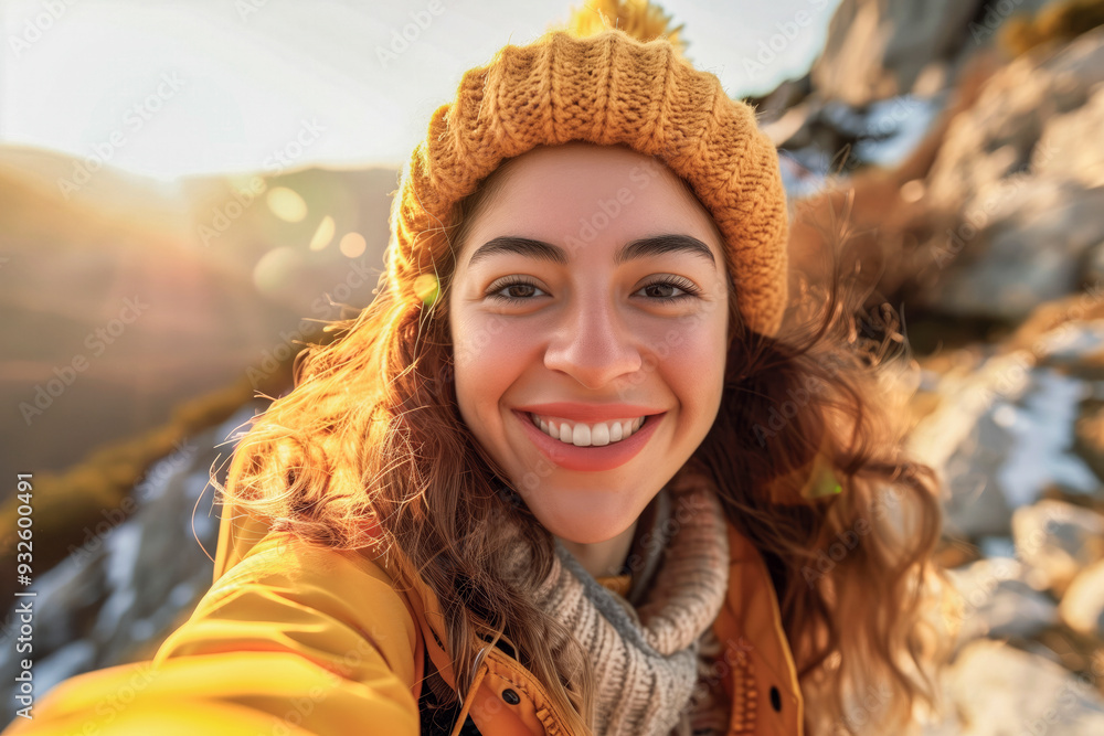 Wall mural portrait of a young hiker who walks through the mountains, happily enjoying her trip through the mou