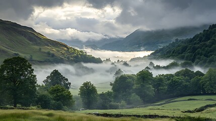 Obraz premium Misty valley with sunlight breaking through the clouds.