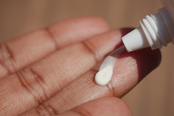  young men using sunscreen cream 