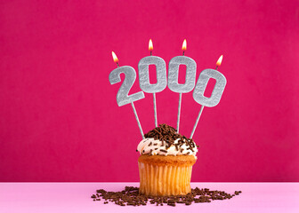 Birthday cupcake with candle number 2000 - Birthday card on pink background
