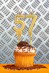 Birthday candle number 57 - Industrial metallic background.