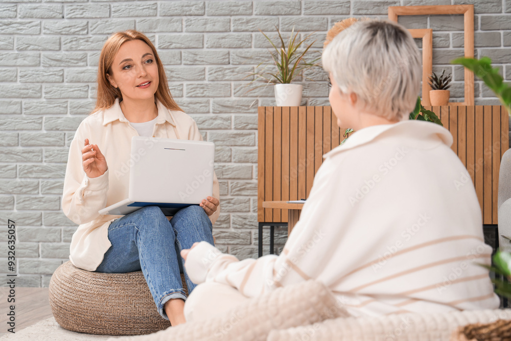 Canvas Prints female psychologist with laptop talking to teenage girl in office