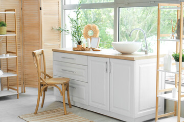 Interior of stylish modern bathroom with decorative olive tree