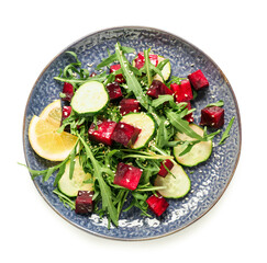 Plate of fresh salad with beet and cucumber on white background