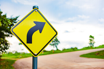 Traffic sign forcing a left turn. Beautiful evening atmosphere on a beautiful road. Driving.
