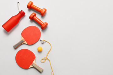 Whistle and sports equipment on grey background