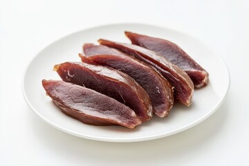 Sliced dried duck breast on white plate isolated on white background
