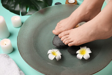 Young woman undergoing spa pedicure in beauty salon
