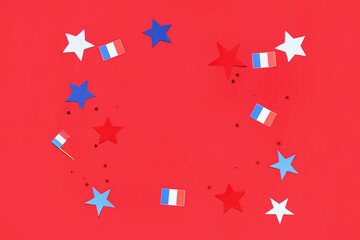 Frame made from French flags, confetti and stars on red background. Bastille Day celebration