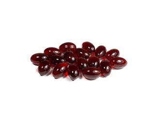 Krill oil capsules isolated on white background. Translucent red softgel capsules of antarctic krill oil. Nutritional supplement with valuable substances