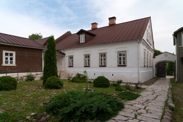 View of the courtyard of a traditional merchant's estate on the main street of Izborsk Pechorskaya...