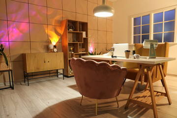 Interior of studio with podcaster's workplace and glowing lamps
