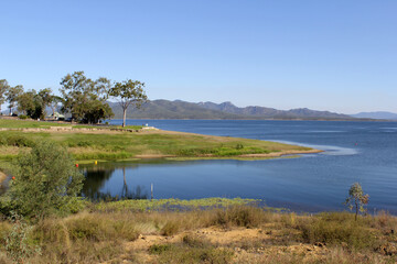 Water, grass, trees and mountains at Lake Awoonga near Gladstone in Queensland, Australia