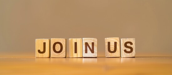 wooden cube blocks make the word JOIN US. Arranged in flat screen style