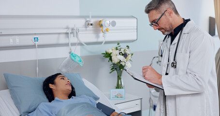 Clipboard, bed and doctor with woman in hospital for healthcare, consultation or cardiology service. Medical chart, discussion and cardiologist with patient for postoperative checkup in clinic.