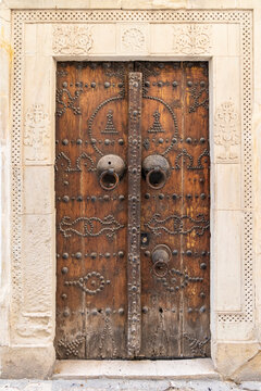 Hammamet, Nabeul, Tunisia. A decorated wooden door on a building.