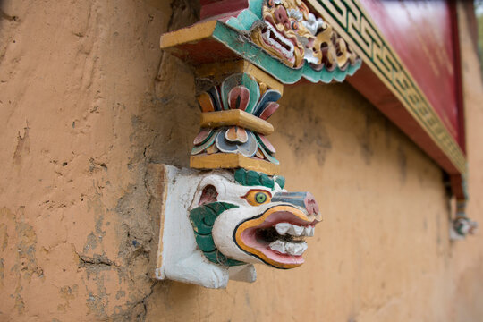 Bhutan, Thimphu. Detail of traditional Bhutanese architecture, ornately carved wall decoration.