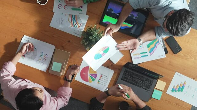 Smart businessman send financial chart to manager at meeting room while investor receive investment report and planning marketing campaign or strategy ay meeting table. Creative startup. Convocation.