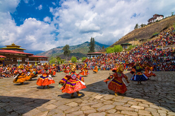 Costumed dancers at religious festivity with many visitors, Paro Tsechu, Bhutan