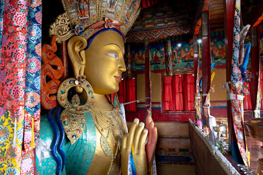 India, Ladakh, Indus Valley, Thiksey, Thiksey Monastery. Details of the Tibetan style statues and artifacts where people come to worship.