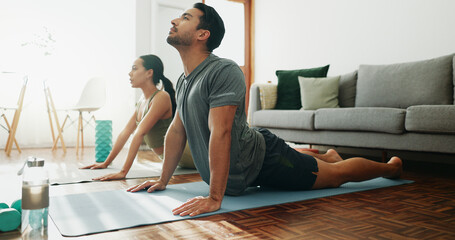 Fitness, couple and stretching in home for yoga, wellness and spiritual healing. Man, woman and cobra pose in pilates for healthy body, activity in relationship and positive mental health on floor