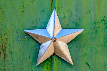 Ukraine, Pripyat, Chernobyl. Decorative silver Soviet star on a green wall.