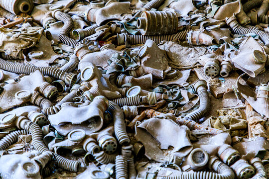 Ukraine, Pripyat, Chernobyl. Gas masks, many of them child-sized, litter the floor of an abandoned school.