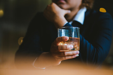 A young businessman holds a glass of whiskey, toasting with friends at an upscale bar. The scene captures the essence of luxury and celebration, with a focus on camaraderie and the nightlife atmospher