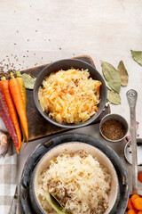 Winter salad on wooden light background. Homemade sauerkraut cabbage withcarrot. Tasty