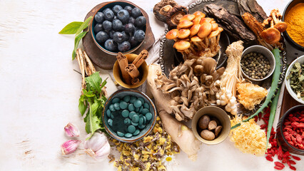 Healthy natural adaptogen. Herbs, spices, mushrooms on light background. Nervine food collection