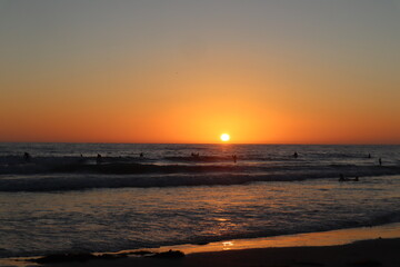 Beautiful San Diego sunset with surfers