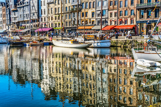 Colorful marina, Inner Harbor, Honfleur, France. Honfleur is famous for its reflections, which inspired Monet