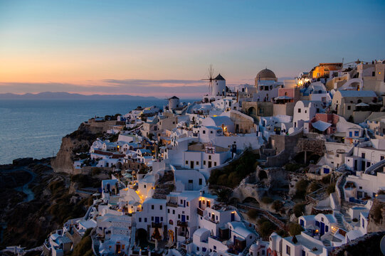 Greece, Santorini, Oia. Evening lights dot the hillside overlooking Santorini, Greece.