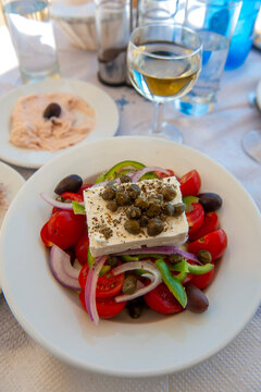 Greece, Santorini, Oia. Feta salad and white wine lunch in Oia, Santorini.