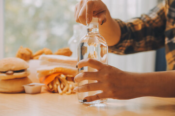 healthy beautiful young woman holding glass of water