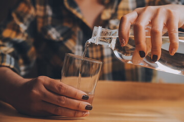 healthy beautiful young woman holding glass of water