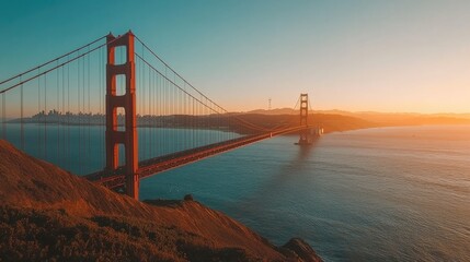Fototapeta premium Golden gate bridge at sunset, iconic landmark glowing in warm evening light