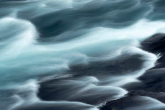 Iceland, Hraunfossar, Hvita River. The Hvita River flow quickly, creating patterns with a slow shutter speed.