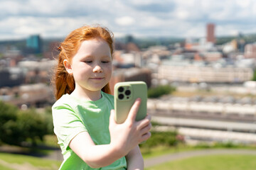 Young Girl Taking Selfie With  Smartphone Against City Backdrop on  Sunny Day