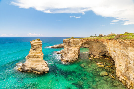 Italy, Apulia, Province of Lecce, Melendugno. The Faraglioni (limestone stacks) of Torre Sant'Andrea. Eroded limestone cliffs above the Adriatic Sea.