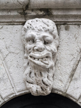 Italy, Venice. Grotesque stone carving of a male gargoyle figure on exterior of Santa Maria Formosa Church.