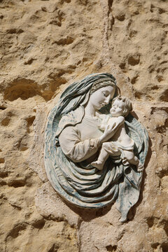 Valletta, Malta. Religious icon fresco of a mother and a child on limestone in the walled city
