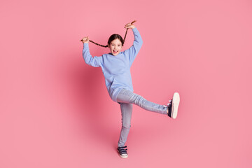 Full size photo of lovely small schoolkid dance pull braids wear hoodie isolated on pink color background