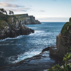 Capture a dramatic coastal scene with rugged cliffs meeting the deep blue sea, and waves crashing...